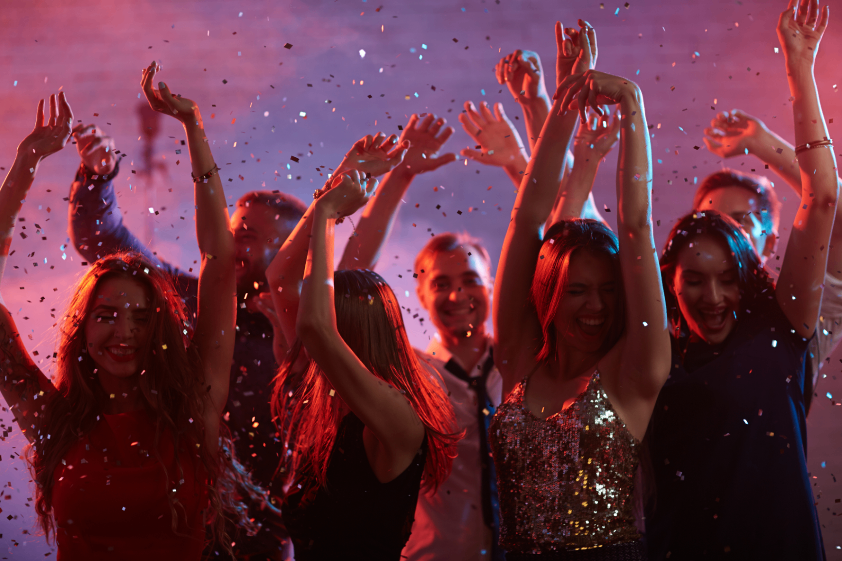 Audience dancing at an energetic live event with confetti
